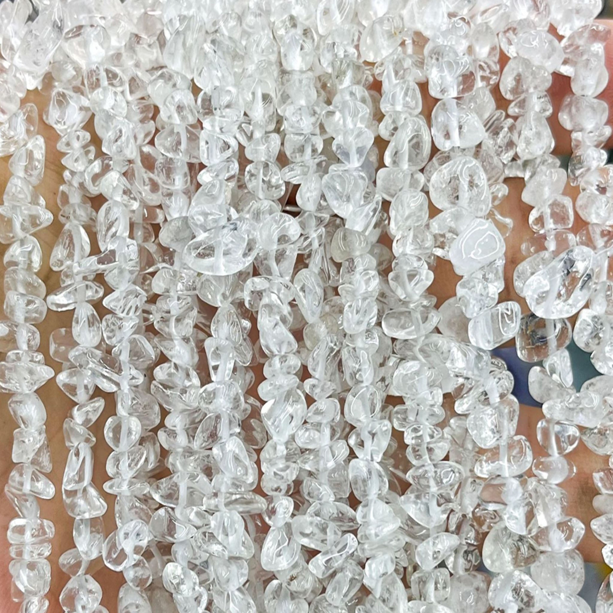 Handmade 7A Clear Quartz Master Healer bracelet on an elastic cord, used for chakra cleansing, energy amplification, and mental clarity.