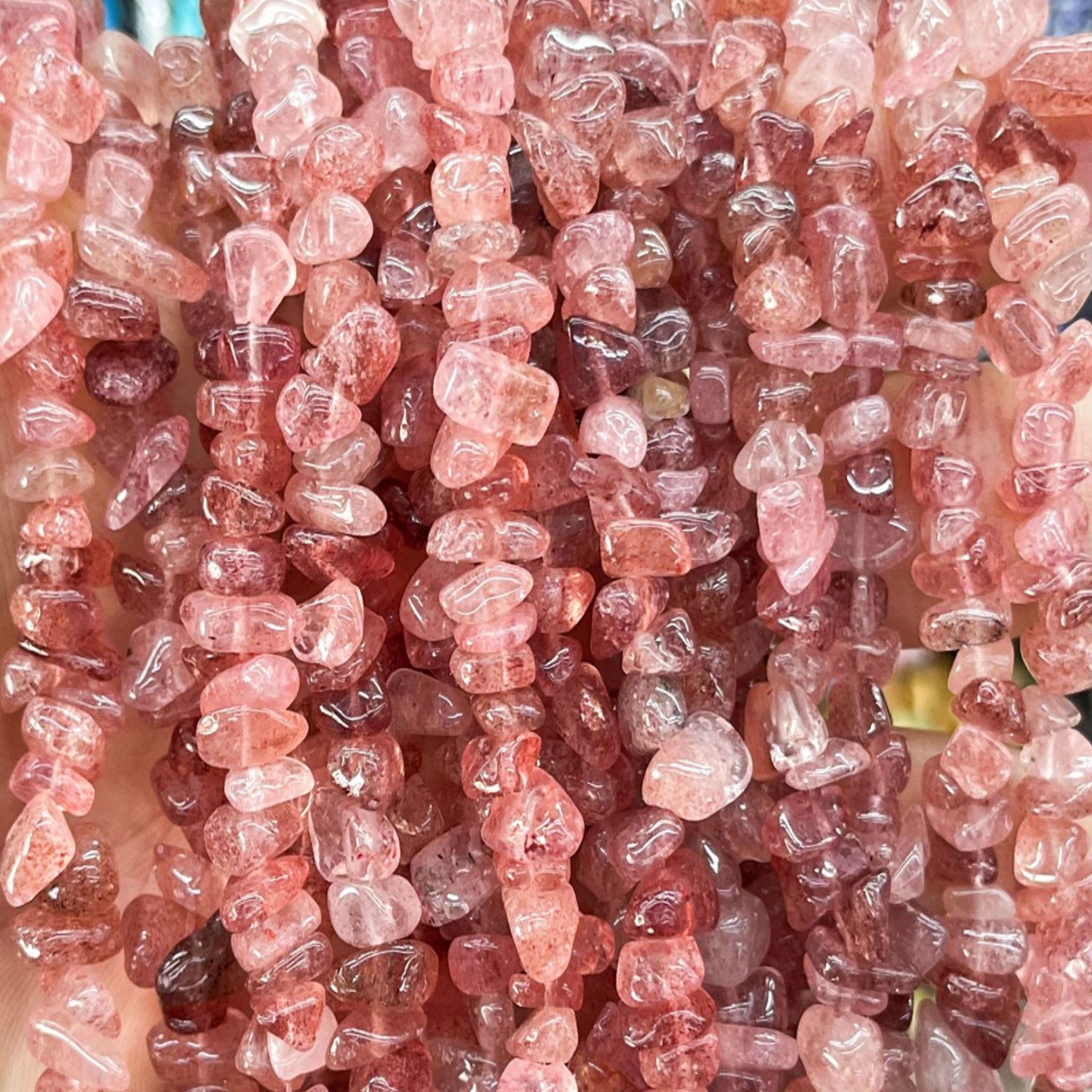 Handmade 7A Strawberry Quartz Master Healer bracelet on an elastic cord, used for chakra cleansing, energy amplification, and mental clarity.