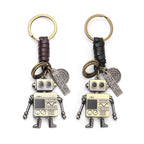 A handcrafted, retro-style robot keychain made of braided genuine leather,  featuring movable limbs, antique bronze finish, and engraved metal plaques "I feel about you"