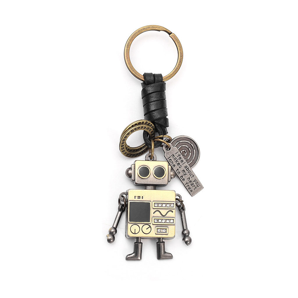 Close-up of a retro robot keychain, showing its movable arms, braided leather cord, and inspirational engraved tags.