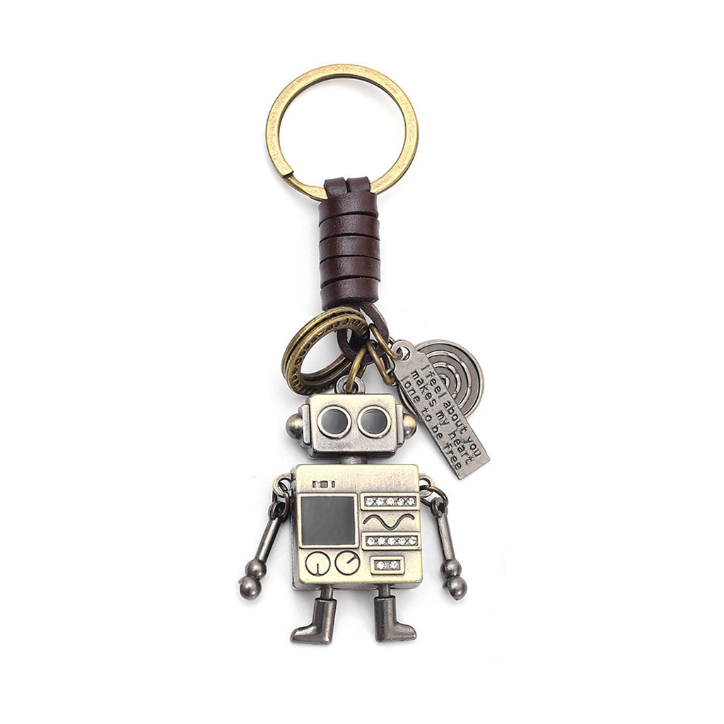 Close-up of a retro robot keychain, showing its movable arms, braided leather cord, and inspirational engraved tags.