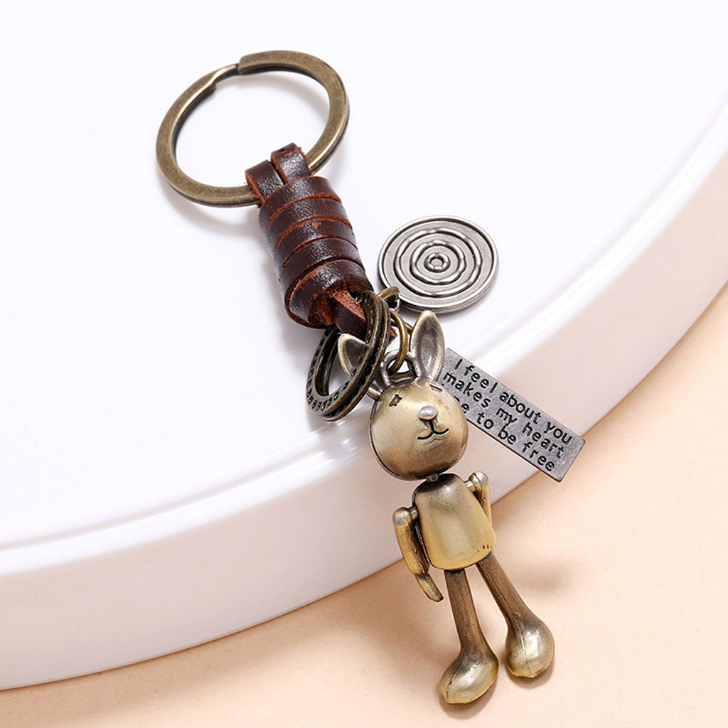 Handmade rabbit leather keychain with punk details, antique finish, and inspirational engraved message.
