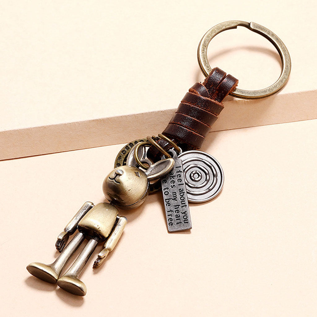 Handmade rabbit leather keychain with punk details, antique finish, and inspirational engraved message.