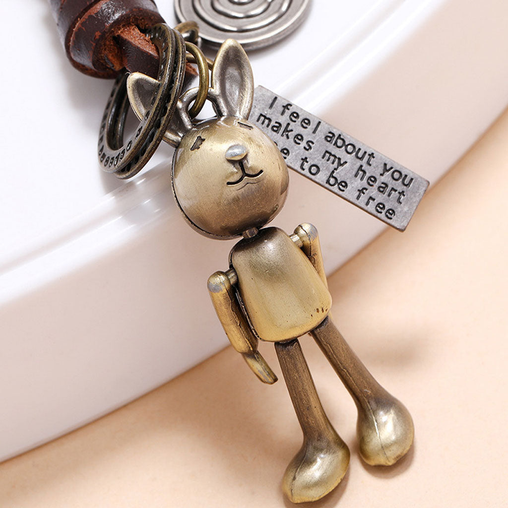 Handmade rabbit leather keychain with punk details, antique finish, and inspirational engraved message.