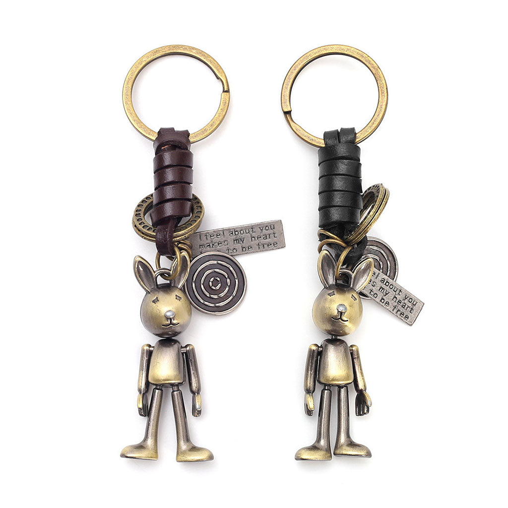Punk-style little rabbit keychains with handwoven genuine leather cords and antique bronze charms. Each rabbit has articulated limbs and hangs from a keyring with a unique engraved plaque reading "I feel about you makes my heart to be free".